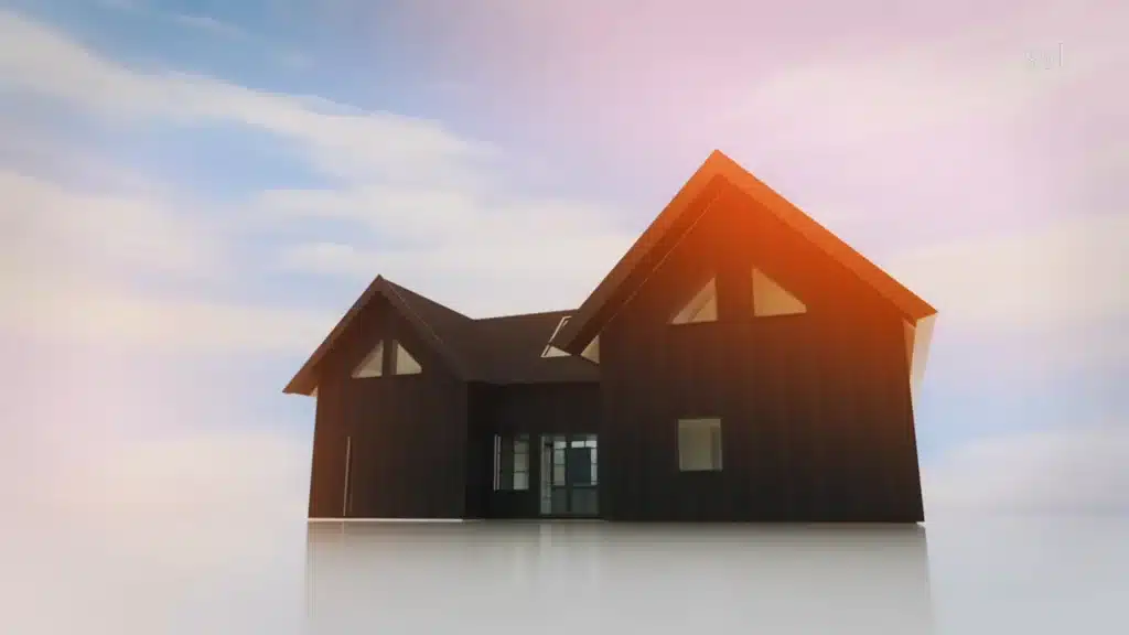 Stiligt - Ett modernt mörkfärgat hus med stora fönster och sluttande tak, mot en ljus himmel med spridda moln.