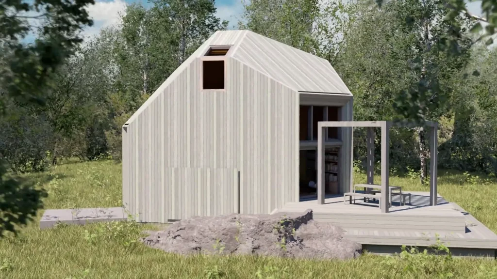 Stiligt - Ett litet, modernt hus i skjulstil med ljusa träsidor, stora fönster och en enkel uteplats, beläget på en gräsbevuxen tomt omgiven av träd.