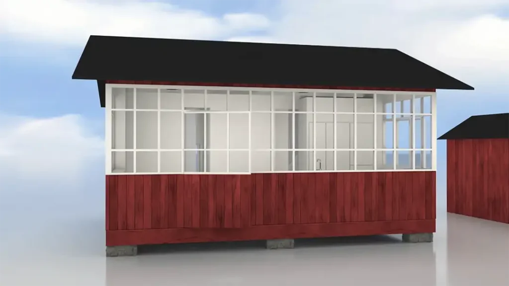 Stiligt - En liten röd träbyggnad med stora vita inramade fönster och ett svart tak, mot en molnig himmelbakgrund.